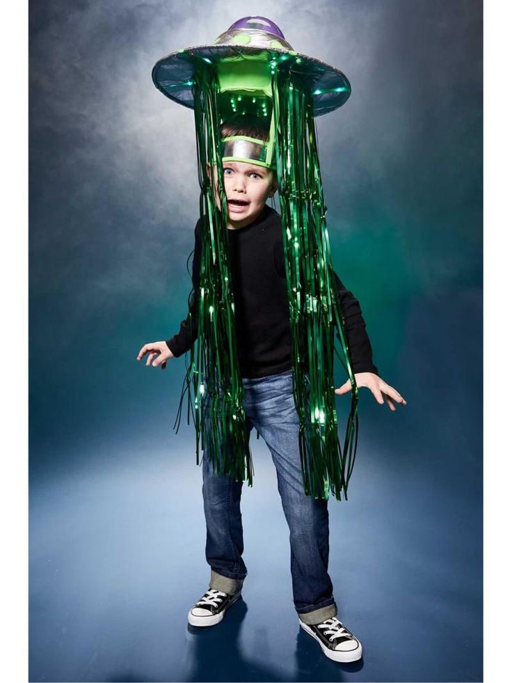 a young boy wearing a green costume and hat