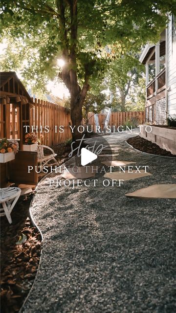 an image of a backyard with gravel on the ground and trees in the back yard