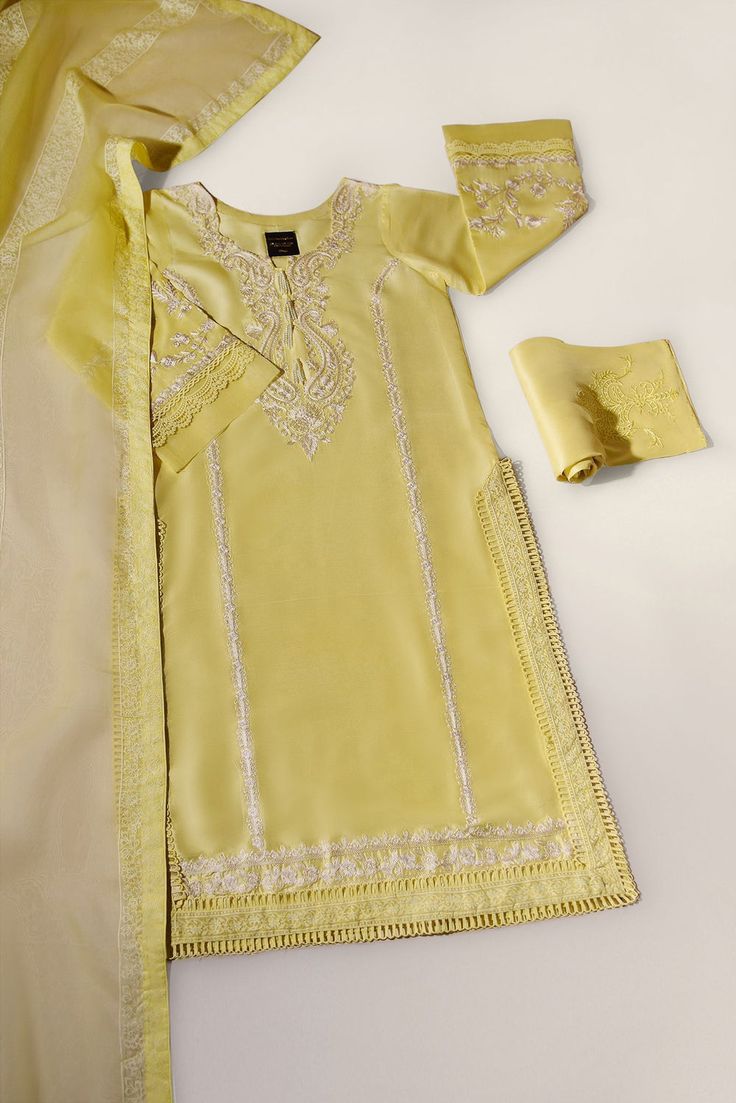 Adorned on pure raw silk 60 gms in a dreamy tone of pastek yellow with intricate embroidery details alongside pretty laces making this an elegant classy feminine design. The pure raw silk pants feature signature Agha Noor motif and the pure organza dupatta is adorned with block print trellis. An ideal look for the fest Luxury Three-piece Suit With Long Sleeves, Velvet Dress Designs, Long Skirt Fashion, Eid Outfits, Baby Dress Design, Simple Pakistani Dresses, Designer Outfits, Embroidery Suits Design, Muslimah Fashion Outfits