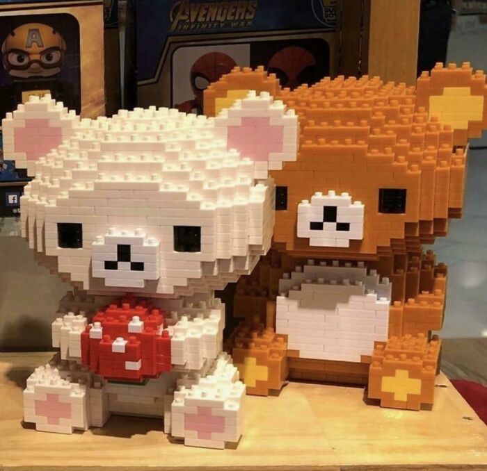 two lego animals sitting next to each other on a table