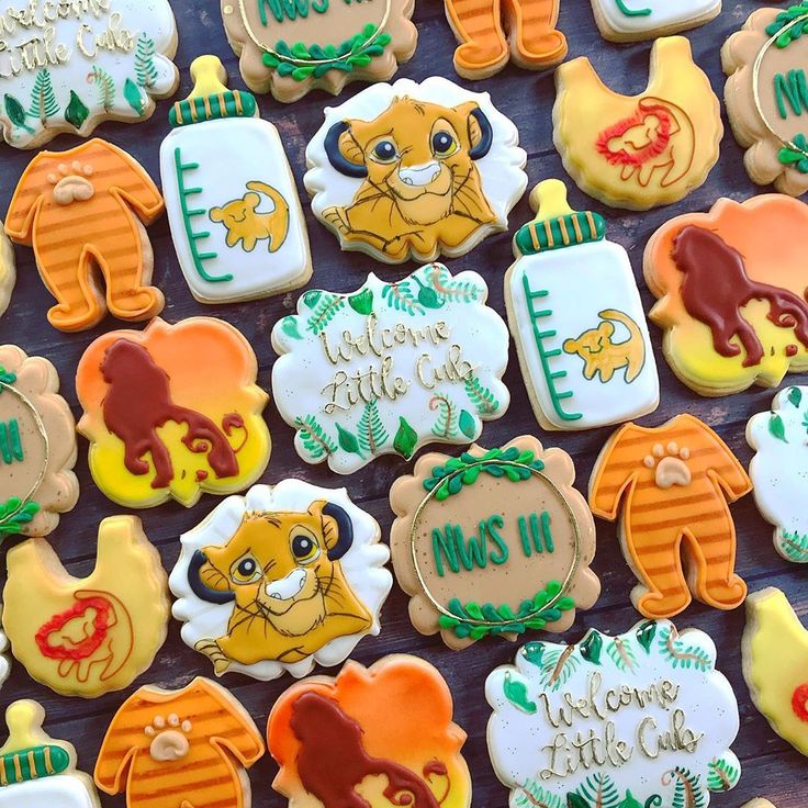 many decorated cookies are displayed on a table