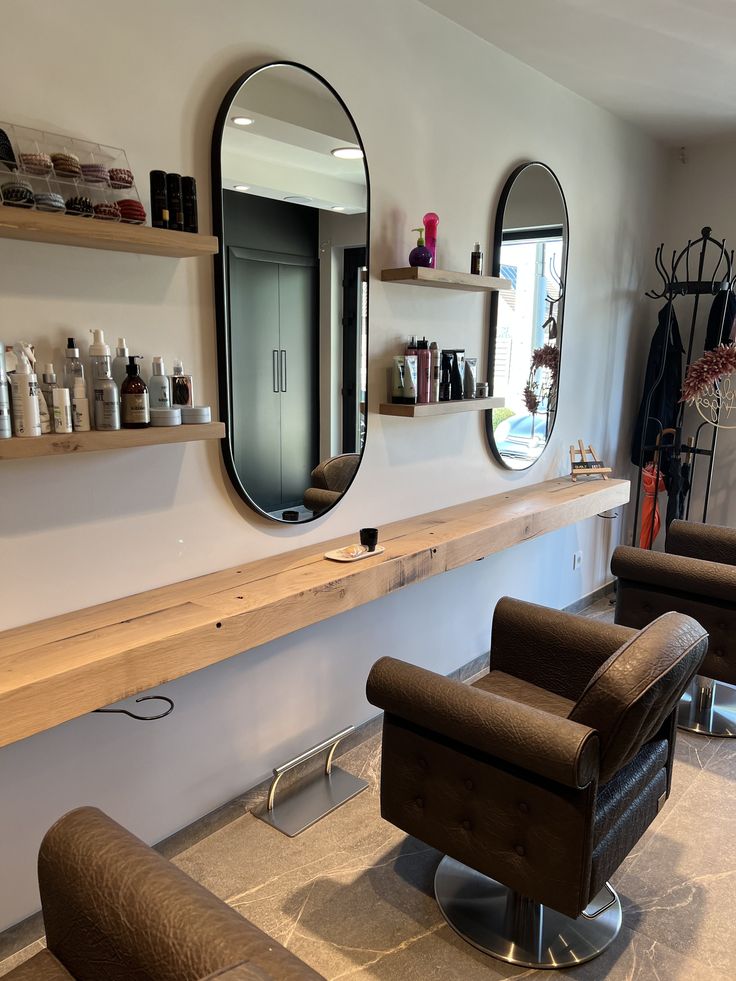 a hair salon with chairs and mirrors on the wall