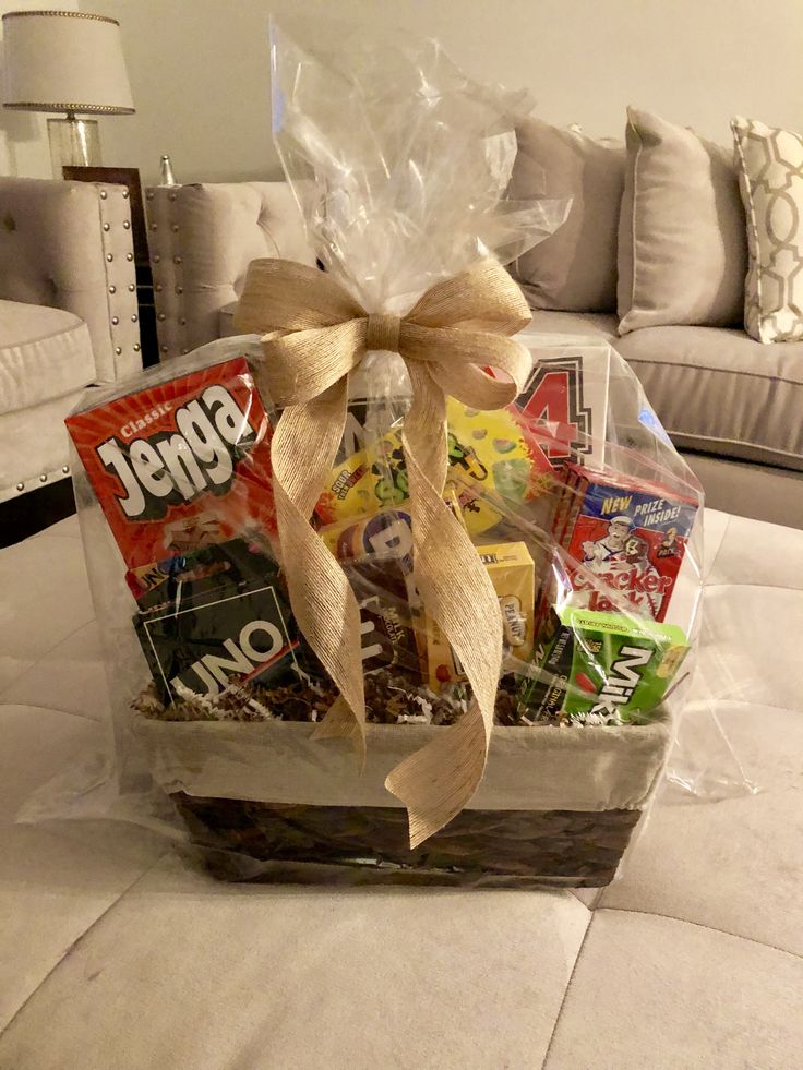 a basket filled with candy and candies on top of a table next to a couch