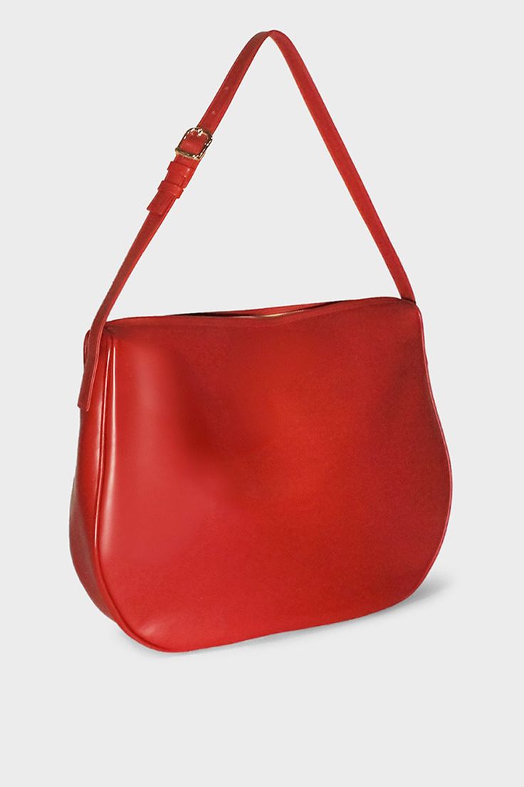 Product Details The Large Saddle in smooth red is a statement piece, with a half-moon shaped body, fine hand turned piping and uncompromised attention to detail. A versatile, large shoulder bag that combines modern elegance with practical functionality and a signature soft slouch. Ideal as a work bag, every day bag or a light travel bag. Handcrafted exclusively in our Melbourne Atelier from the finest Italian soft smooth leather. Delivered in an exclusive A-ESQUE cotton drawstring dust bag for preservation and luxury. Product Features • Material: 100% Italian soft smooth aniline leather • Lining: 100% suede lining • Hardware: Gold tone • Height: 33cm | 13" • Width: 8.5cm | 3.35" • Length: 40cm | 15.75" • Adjustable Shoulder Strap: 74cm | 29.1" •Pocket: Two internal slip pockets Elegant Red Leather Saddle Bag, Modern Red Shoulder Bag, Elegant Red Shoulder Bag With Round Handle, Luxury Red Saddle Shoulder Bag, Luxury Red Saddle Bag For Formal Occasions, Luxury Red Shoulder Bag With Round Handle, Red Business Bag With Smooth Grain, Elegant Red Saddle Bag For Travel, Modern Red Hobo Bag