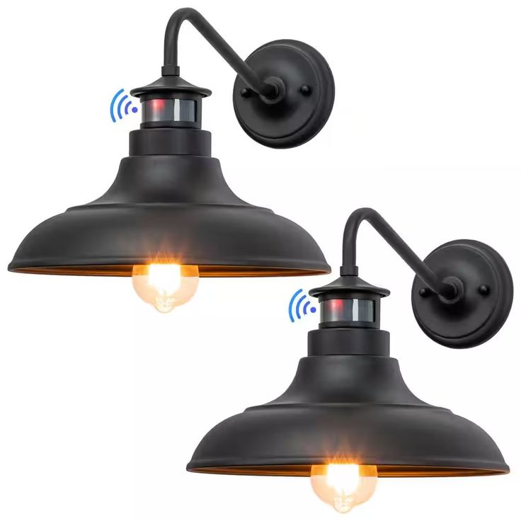 two black wall lights with one light on each side and the other on top of it