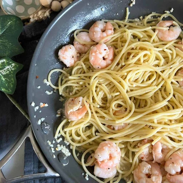 pasta with shrimp and parmesan cheese in a skillet