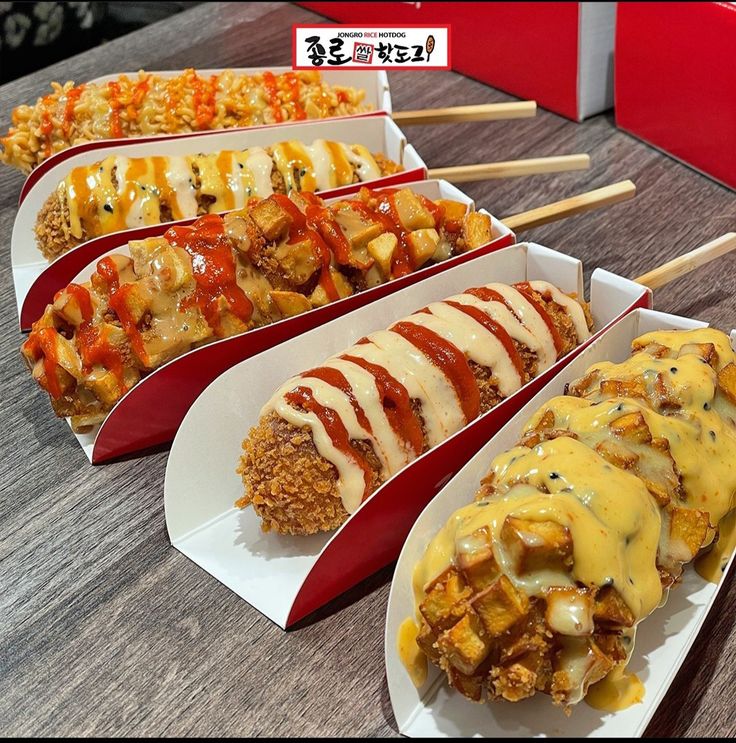 several trays filled with different types of food on wooden table next to each other