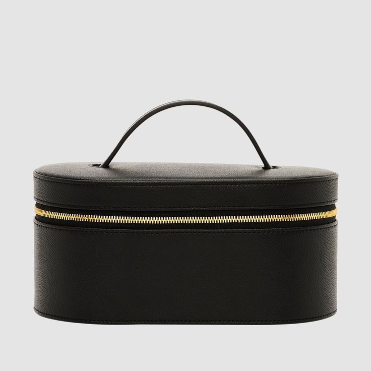 Crafted from our luxurious, textured Recycled Saffiano Leather (outer) and smooth nylon lining (interior), the Essential Vanity Case is a durable, reinforced leather case designed with gold hardware for added elegance. A separate pouch is also included to store your prized possessions, and elastic straps on the lid can securely hold your makeup brushes in place. Dimensions: 11cm (H) x 22cm (W) x 13cm (D) Pictured here: Our "Serif" font in size 24pt, in Gold.SKU code: VANITCSE-RS-BLA-GO-1-WKM Luxury Cases With Removable Pouch, Classic Rectangular Case, Modern Business Case With Removable Pouch, Elegant Rectangular Case With Removable Pouch, Elegant Case With Removable Pouch, Classic Cases With Removable Pouch For Daily Use, Elegant Portable Cases For Everyday Use, Elegant Portable Cases For Business, Luxury Case With Zipper Closure For Everyday Use