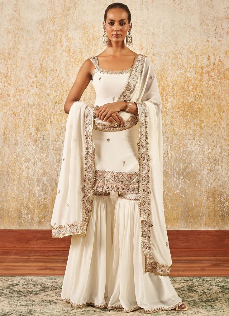 Off White Embroidered Gharara Suit – Lashkaraa Georgette Sharara With Resham Embroidery For Reception, Resham Embroidered Georgette Sharara For Reception, Bollywood Style Georgette Sharara For Reception, Georgette Sharara For Diwali Designer Wear, Designer Georgette Sharara For Diwali, Festive Georgette Sharara With Mirror Work, Eid Georgette Sharara With Mirror Work, Eid Sharara With Mirror Work In Georgette, Dabka Work Georgette Sharara For Diwali