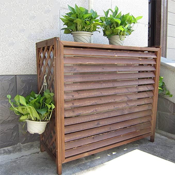 two potted plants sitting on top of a wooden slatted planter next to a window