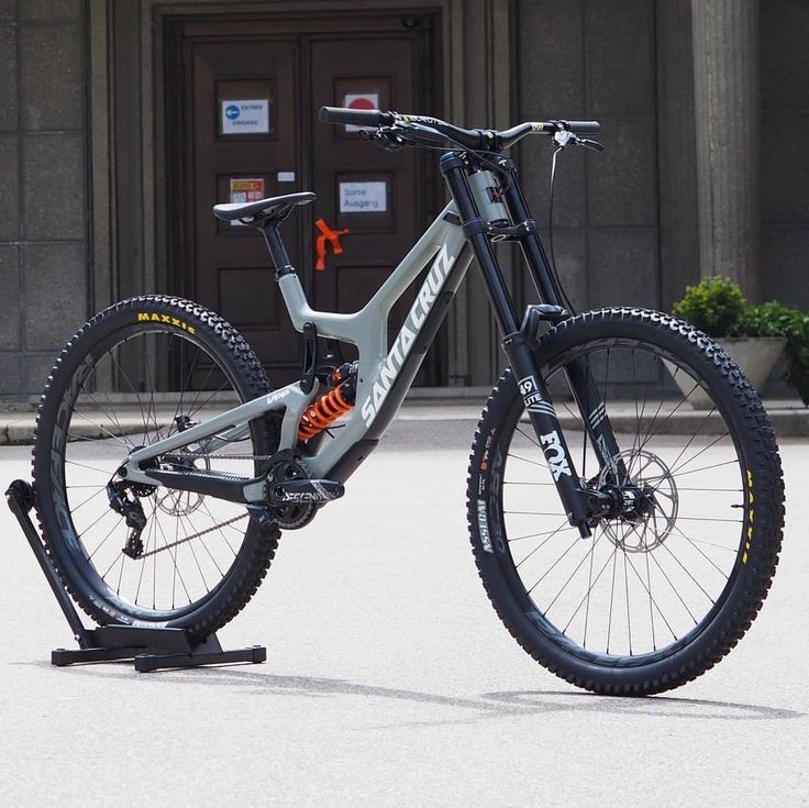 the bike is parked in front of a building