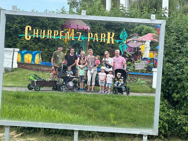 a group of people standing next to each other in front of a sign with the words churpealz park on it