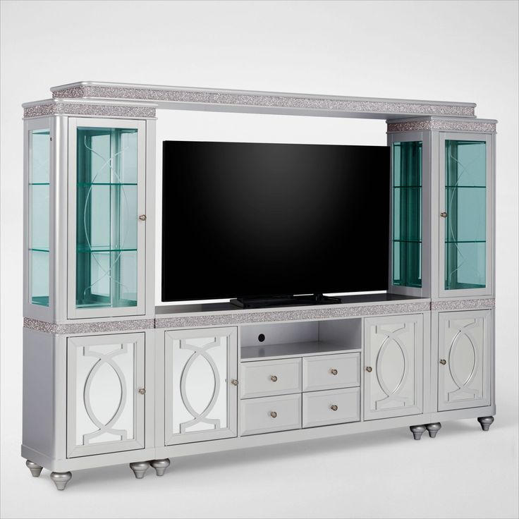 a white entertainment center with glass doors and a flat screen tv mounted on it's side