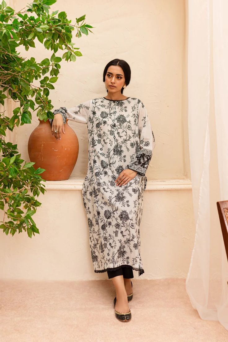 BATIK Zahviya 2Pc - Printed Lawn Dress Ready to wear 2pc dress Flaunt this artfully printed set made from our premium quality Pima lawn in the shades of pearl white. Elegantly printed paneled shirt comes with an embellished neckline - details include lace finishing at neckline and hem. Sleeves are loose fit, adorned with contrasting printed border – finished with lace. Paired with dyed cambric trousers. Disclaimer: Colors may slightly vary due to lighting Premium quality Pima lawn Embellished ne White Tunic Sets For Summer, Eid Floral Print Tunic Kurta, Elegant Floral Print Tunic Kurta, Spring Tunic Sets With Printed Motifs, Festive Floral Print Tunic Set, Spring Tunic Sets With Digital Print, Eid Tunic Kurta With Digital Print, Spring Printed Tunic Sets, Eid Digital Print Straight Kurta Dress