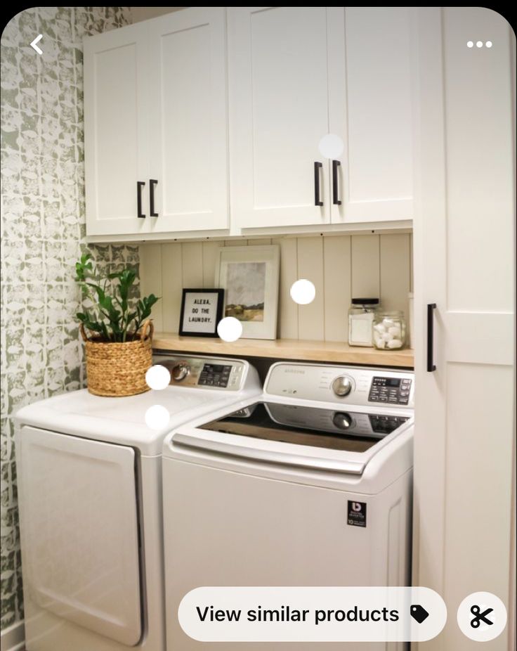 a white washer and dryer sitting next to each other in a laundry room