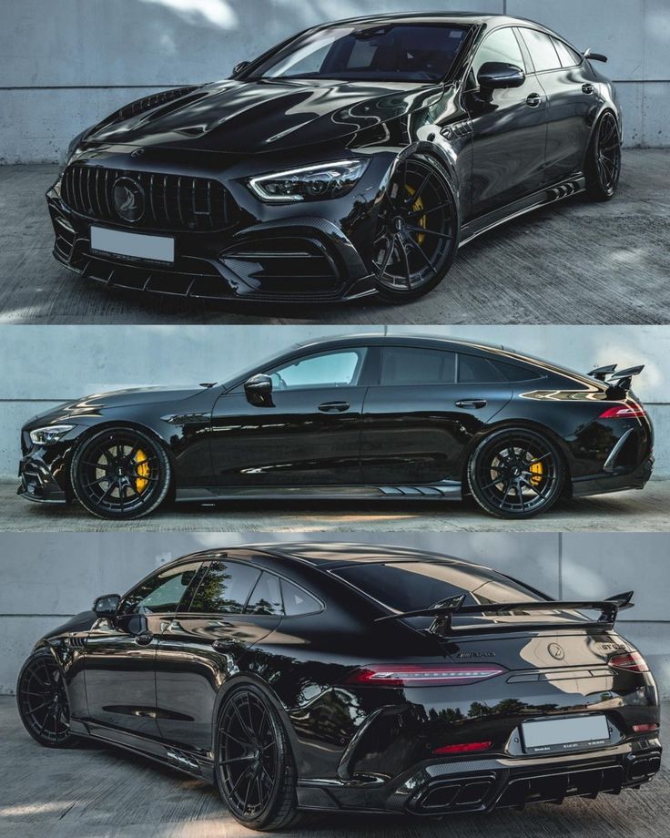 two black cars parked next to each other in front of a white wall and another one with