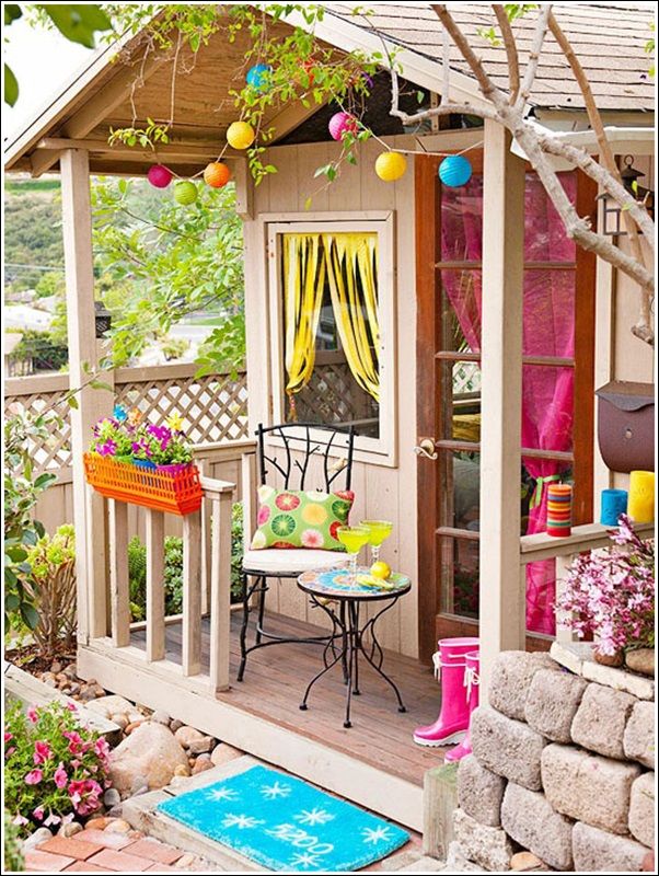 a small patio with a table and chairs on the porch area next to a tree