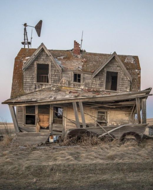 an old run down house in the middle of nowhere