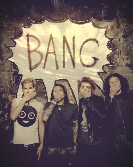 four young men standing in front of a sign that says bang