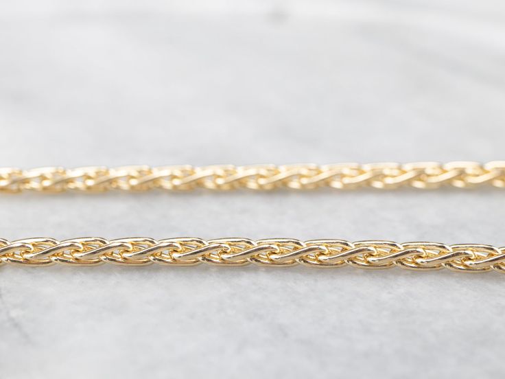 This chain is in excellent condition, and it's a piece that is going to be useful and worn frequently for years to come. The style of the chain is loose enough to allow for movement when worn, preventing the chain from being tangled and feeling very nice on the skin. The link style is known as a wheat chain, due to it's straight, yet ever so slightly curved links that when woven together look like the tops of wheat! Metal: 14K Yellow Gold Width of Chain: 2.8 mm Length of Chain: 22 Inches Marks: Jewelry Basics, Chain Layering, Basic Jewelry, Yellow Gold Necklace, Layering Necklace, Chain Jewelry, Hand Engraving, Eternity Bands, Vintage Necklace