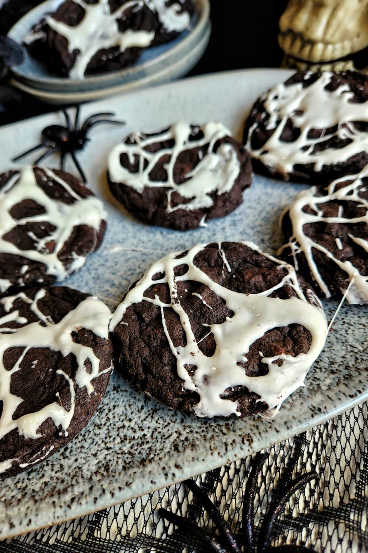 chocolate cookies with white icing on a plate