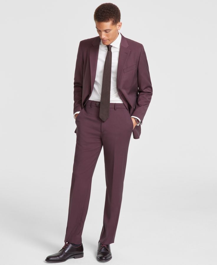 a man in a purple suit and tie