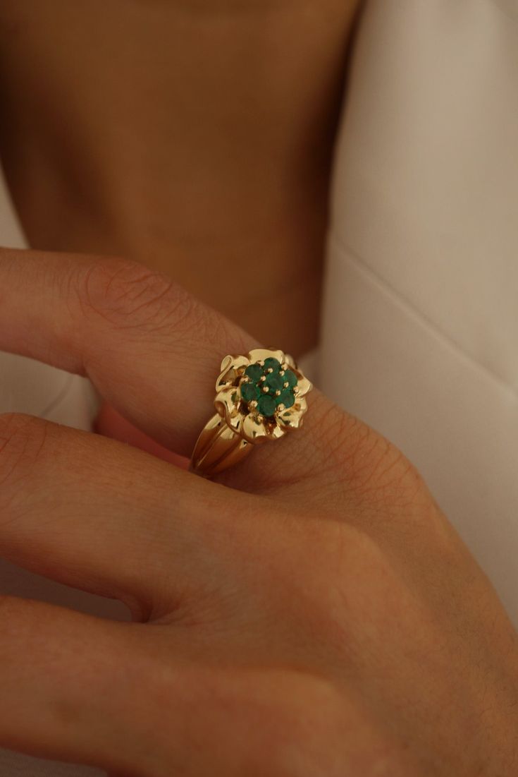 With its gorgeous flower pattern and dazzling green emerald gemstones, Aurora is sure to make a statement wherever you go. Please allow 1-2 weeks for delivery. Timeless Green Birthstone Jewelry, Timeless Green Emerald Cut Jewelry, Timeless Green Emerald Birthstone Ring, Elegant Cluster Emerald Ring For May Birthstone, Timeless Emerald Cut Green Jewelry, Green Emerald Wedding Ring With 17 Jewels, Elegant Flower Jewelry For May Birthstone, Elegant Green Emerald Ring, May Birthstone Cluster Emerald Ring