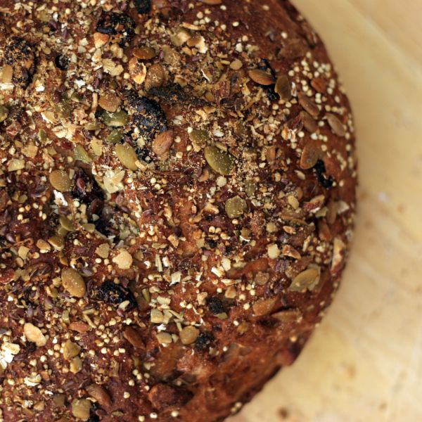 a loaf of bread topped with nuts and seeds