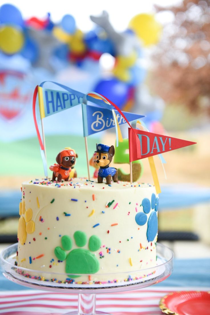 a birthday cake with two figurines on top