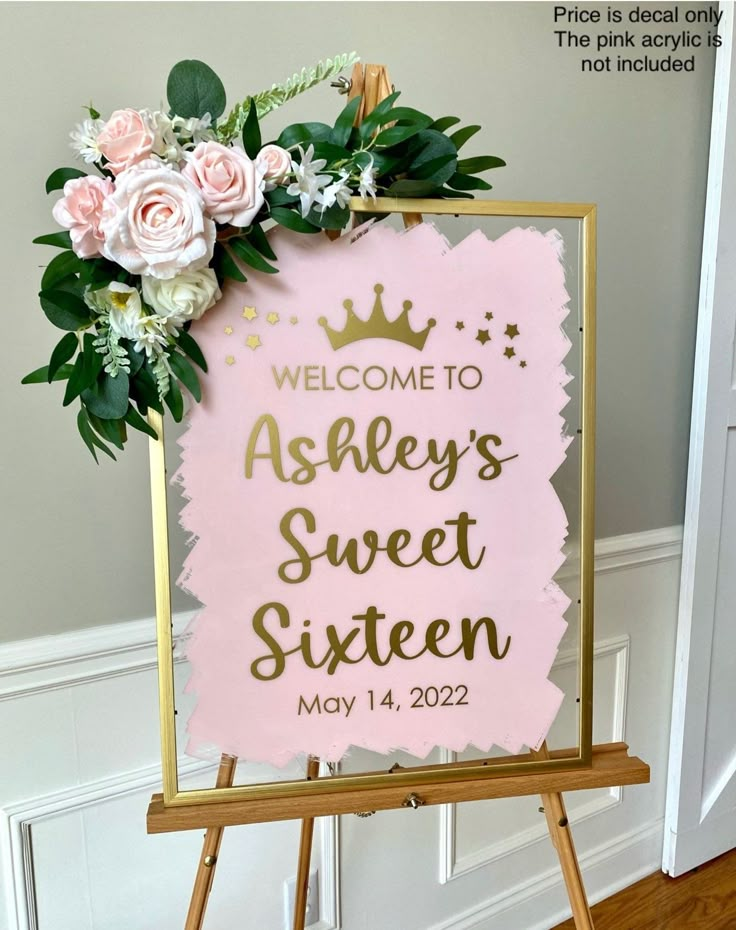 a welcome sign with flowers and greenery on it for a sweet sixteen birthday party