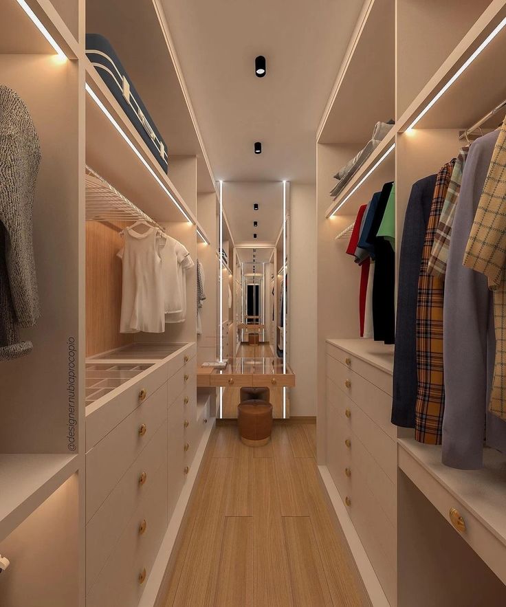 an empty walk - in closet with wooden floors and white walls, illuminated by recessed lighting