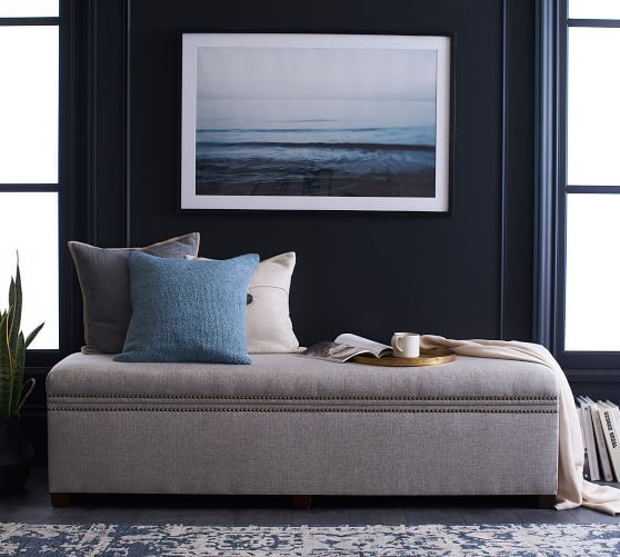 a living room with a couch, coffee table and potted plant