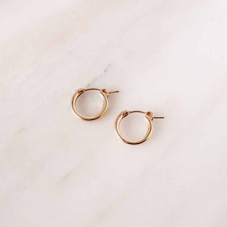 Plain Jane has a point, these are *basic* perfection and a must-have staple for every jewelry collection! DETAILS Available in 14k Gold Filled or Sterling Silver. Each hoop measure approximately 15mm across. Want to add charms on to these hoops? These hoops are compatible with all of our Add-On Charms. Classic Circle Hypoallergenic Earrings, Classic Hypoallergenic Circle Earrings, Classic Hypoallergenic Circular Earrings, Classic Hypoallergenic Jewelry For Everyday, Simple Everyday 14k Gold Huggie Earrings, Simple 14k Gold Huggie Earrings For Everyday, Everyday Simple 14k Gold Huggie Earrings, Tarnish Resistant Small Hoop Jewelry For Everyday, Classic Hypoallergenic Circular Jewelry