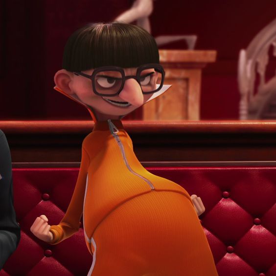 the animated character is dressed in an orange outfit and black glasses, standing next to a red couch