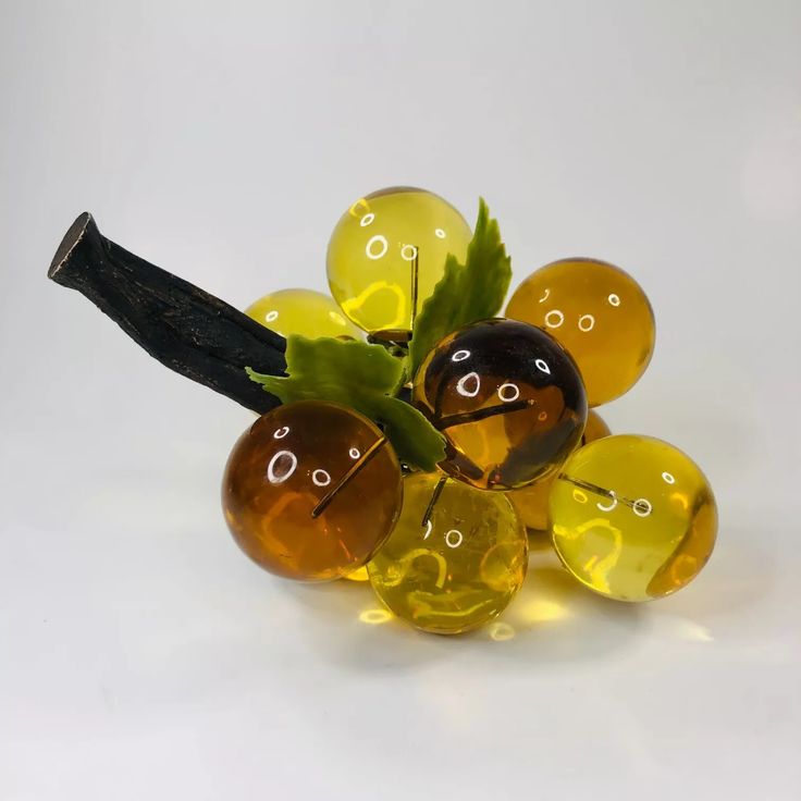 a bunch of glass balls sitting on top of a table next to a wooden stick