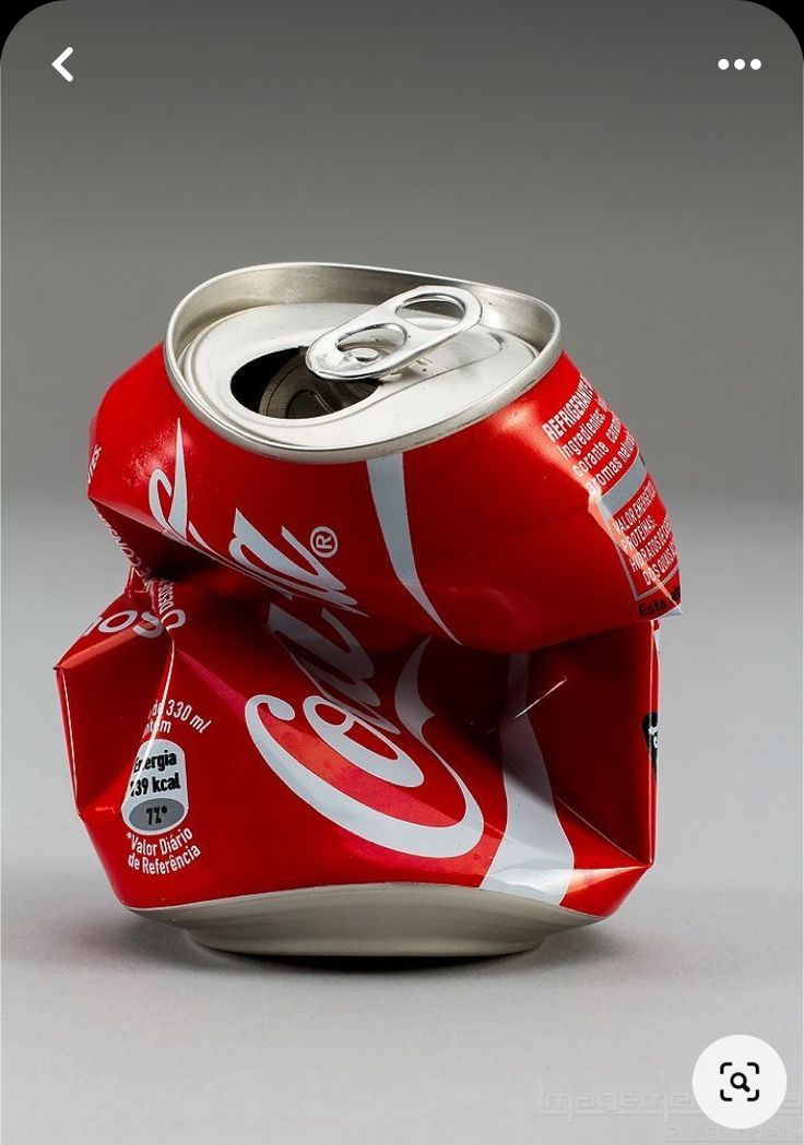 an open can of soda sitting on top of a table