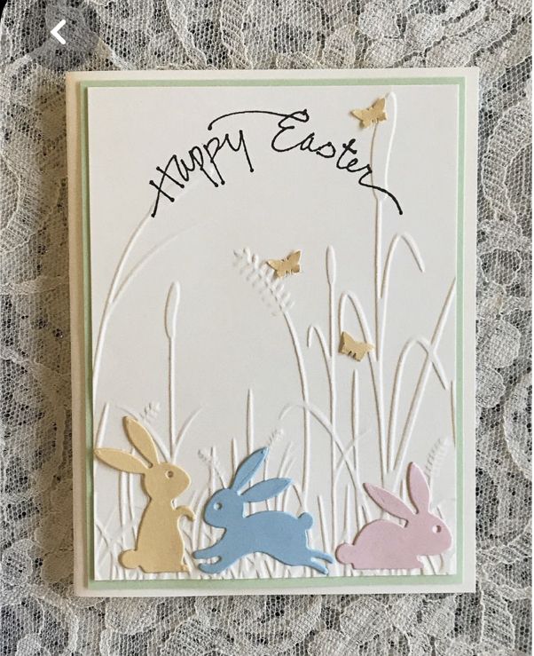 a happy easter card with rabbits and butterflies