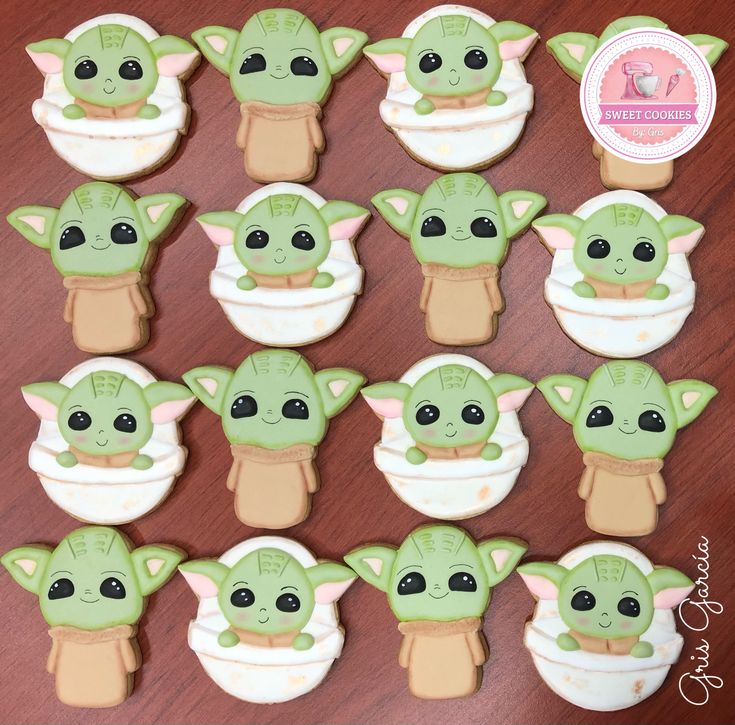 there are many decorated cookies in the shape of baby yoda's