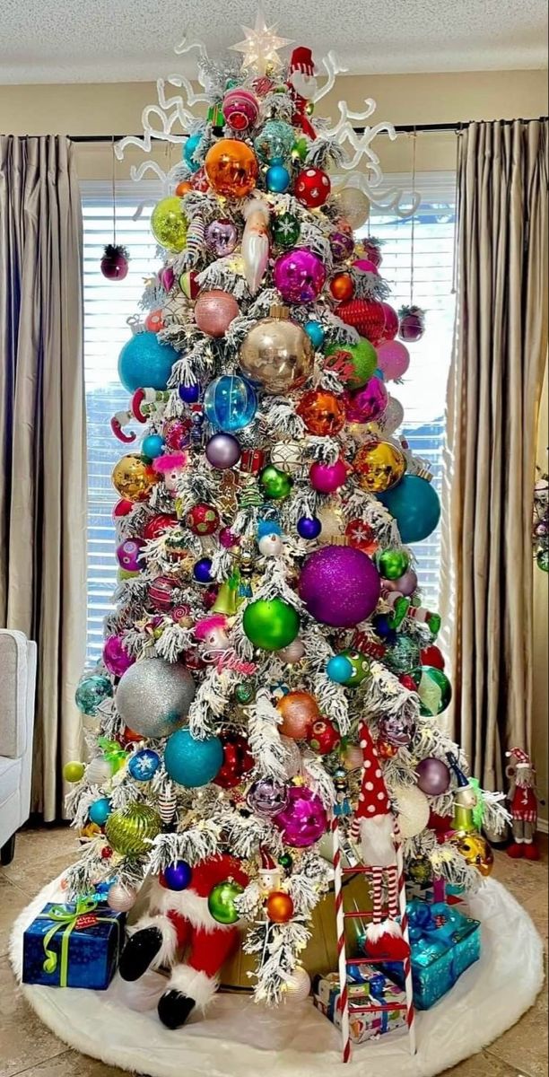 a brightly colored christmas tree in a living room