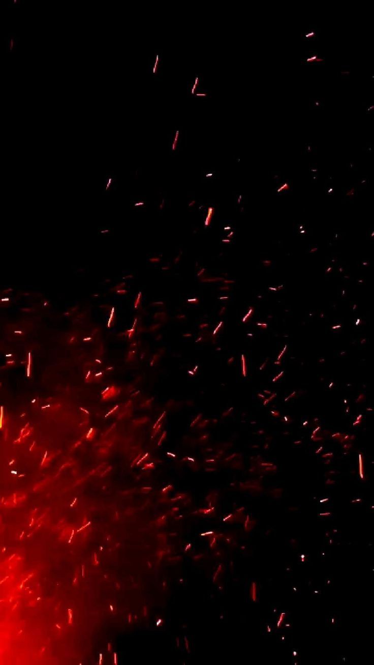 red and black fireworks are lit up in the night sky with bright sparks coming from them