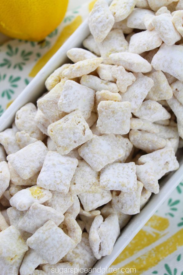 a bowl filled with white dog food next to a lemon and some other items on a table