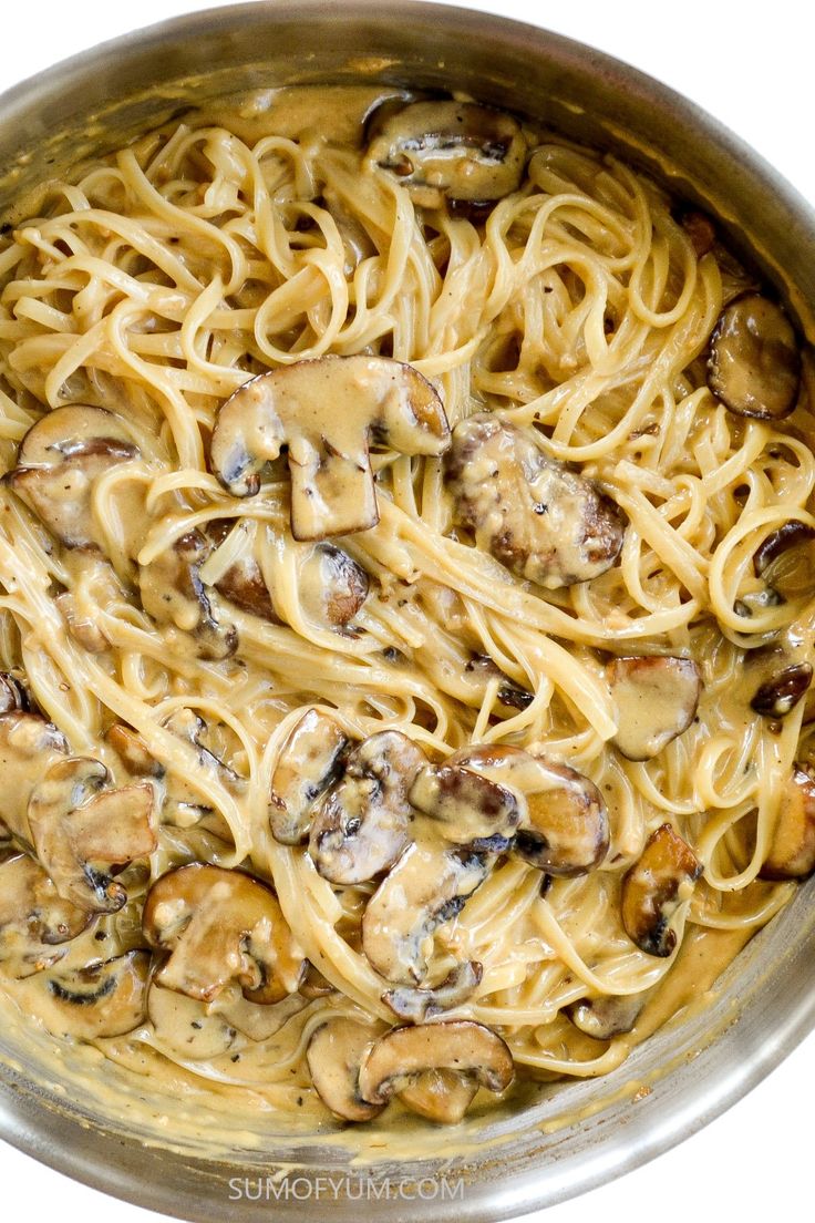 a pan filled with pasta covered in mushrooms