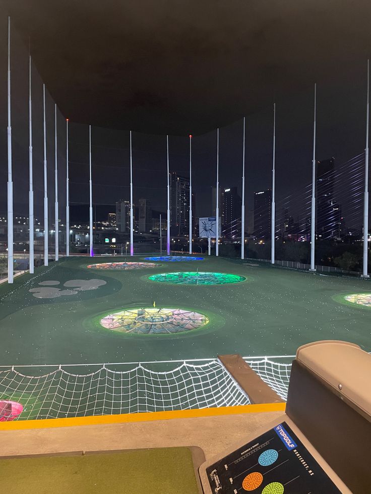 a miniature golf course in the middle of a city at night with lots of lights