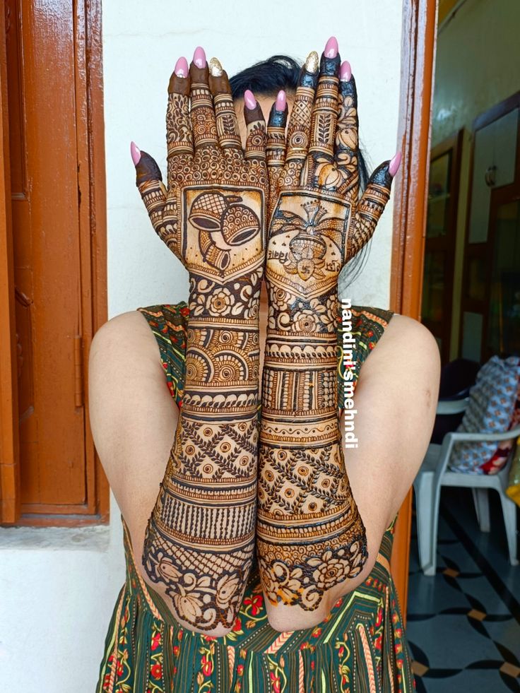 a woman with her hands covered in henna