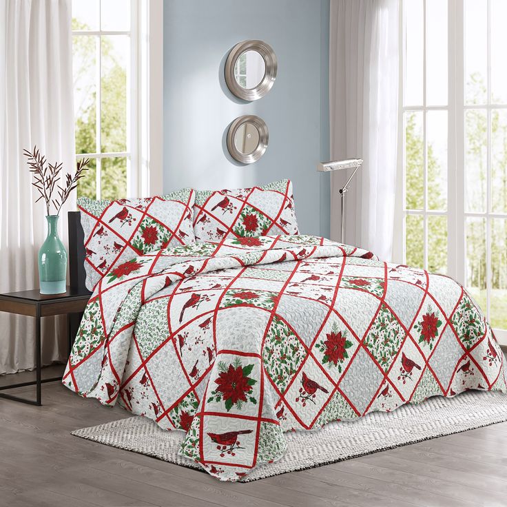 a bed covered in a red and white christmas quilt