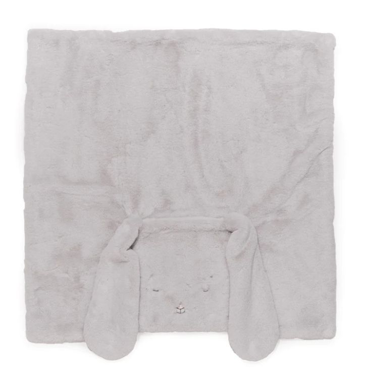 a white blanket with bunny ears on the front and back of it's head