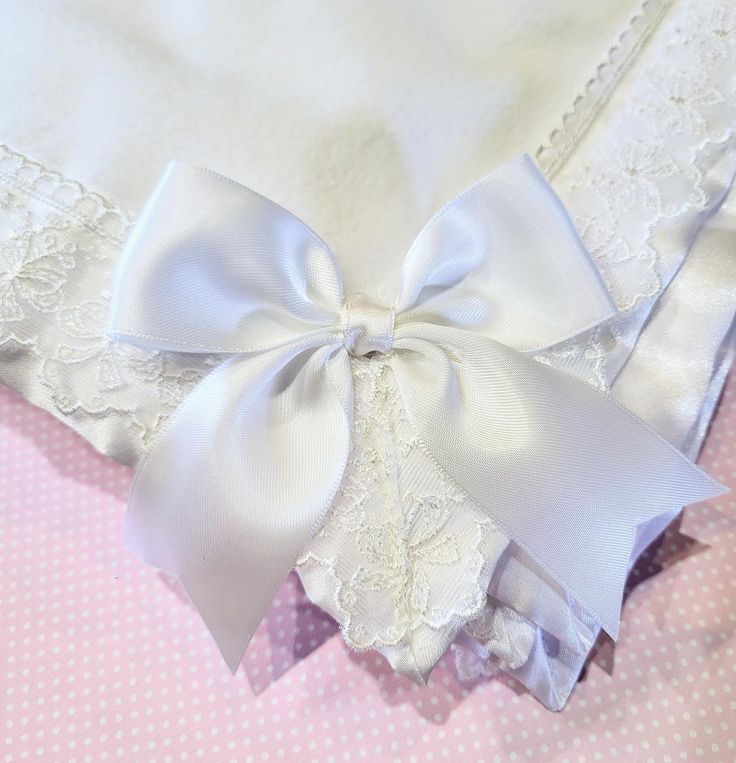 Beautiful  white, satin, lace trimmed with a satin tied bow all ready for that special occassion.  Perfect for a christening,  blessing,  or a baptism for a very special baby 👶 girl.  This blanket is a very light weight soft acrylic blanket that is perfect for drapping around or over during the ordinance or celebration.  Trimmed with a beautiful  1 1/2" nylon embroidered  lace that has beautiful  little bows on it.  It is trimmed with white satin under the lace that makes it so stunning!  The size is 30"×40". $29.95 Elegant Baptism Dress With Satin Bow, White Baptism Dress With Bow, Elegant White Baptism Dress With Bow, White Baptism Dress With Satin Bow, White Satin Baptism Dress With Satin Bow, White Blanket, Satin Bow, White Satin, Embroidered Lace