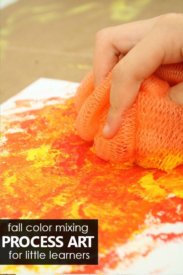 a person is painting with orange and yellow colors on the paper that says fall color mixing process art for little learners