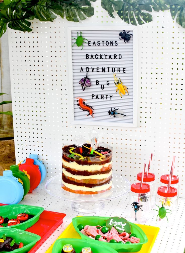 a table topped with a cake covered in frosting