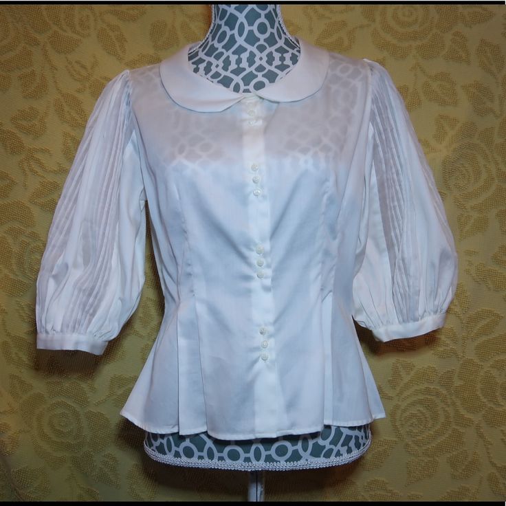 Designed By Maha Barsom 100% Cotton Excellent Condition Still Has Tags Original Price $595 This Button Up Has Pleated Puffy Half Sleeves. With A Peterpan Collar. Also It It Buttoned Down In 4 Section Of 3 Mini White Buttons. Fitted Collared Tops With Pearl Buttons, Classic Fitted Blouse With Pearl Buttons, Formal Fitted Tops With Pearl Buttons, Elegant Fitted Tops With Covered Buttons, Fitted Tops With Pearl Buttons For Work, Fitted Workwear Tops With Pearl Buttons, Classic Formal Blouse With Pearl Buttons, Classic Fitted Padded Blouse, Formal Fitted Blouse With Back Button Closure